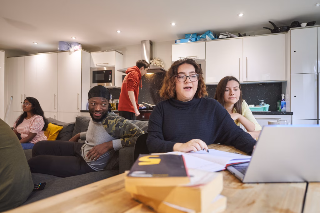 Group of students in a student residence kitchen and communal area